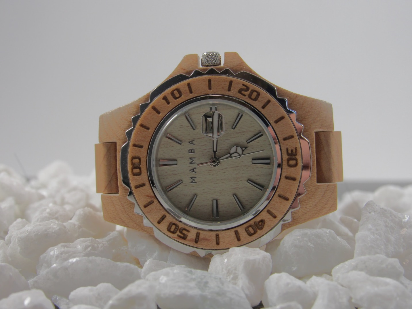 A watch on a white surface Description automatically generated with low confidence